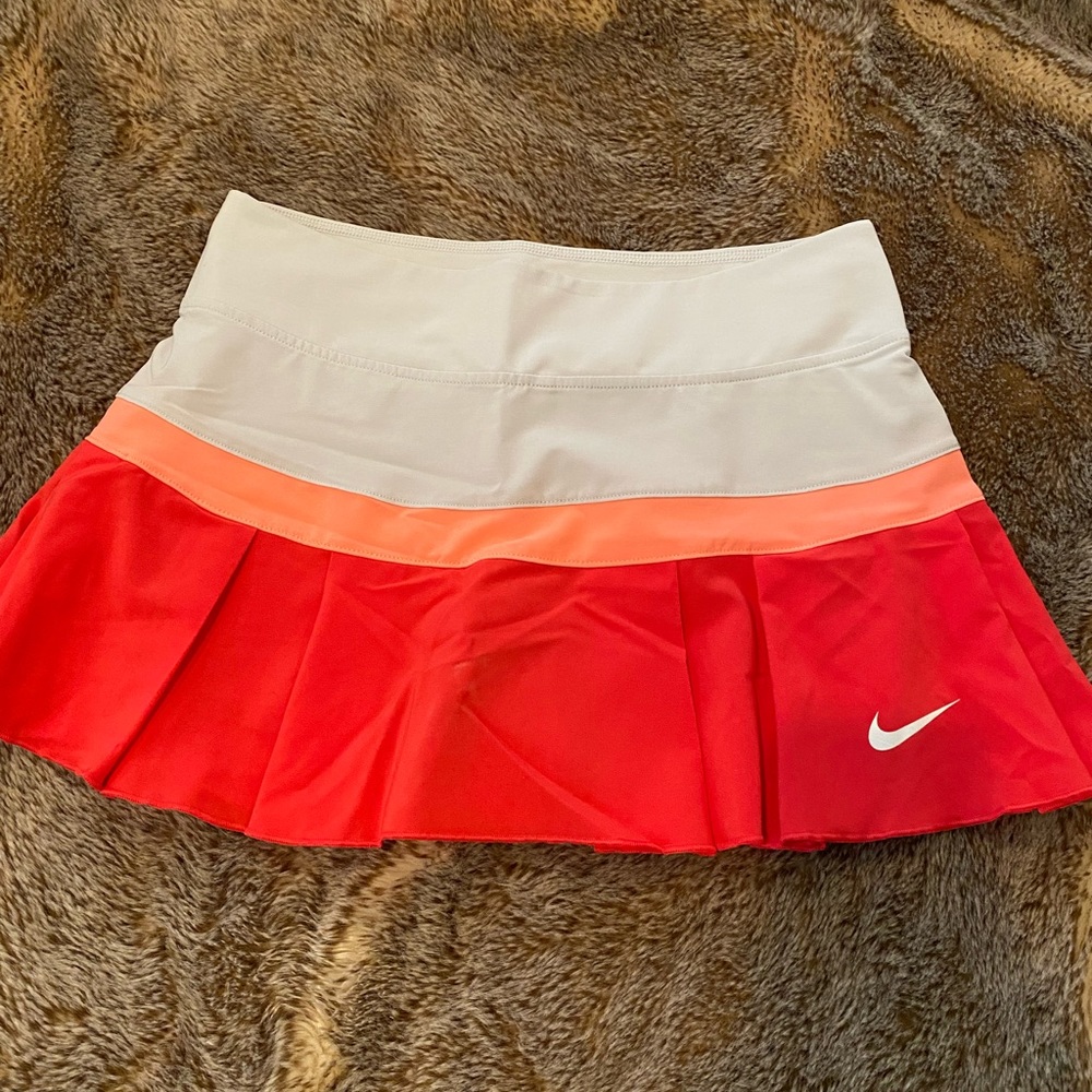 Nike Dri-Fit tennis skirt. Size XS. In a red/orange stripe pattern.